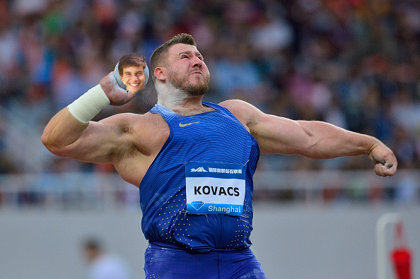Weirdly happy kid's face is on shotput being heaved by frightening burly man