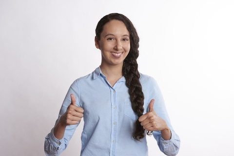 Woman with two thumbs up