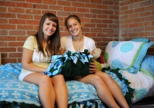 two girls sitting in a dorm room